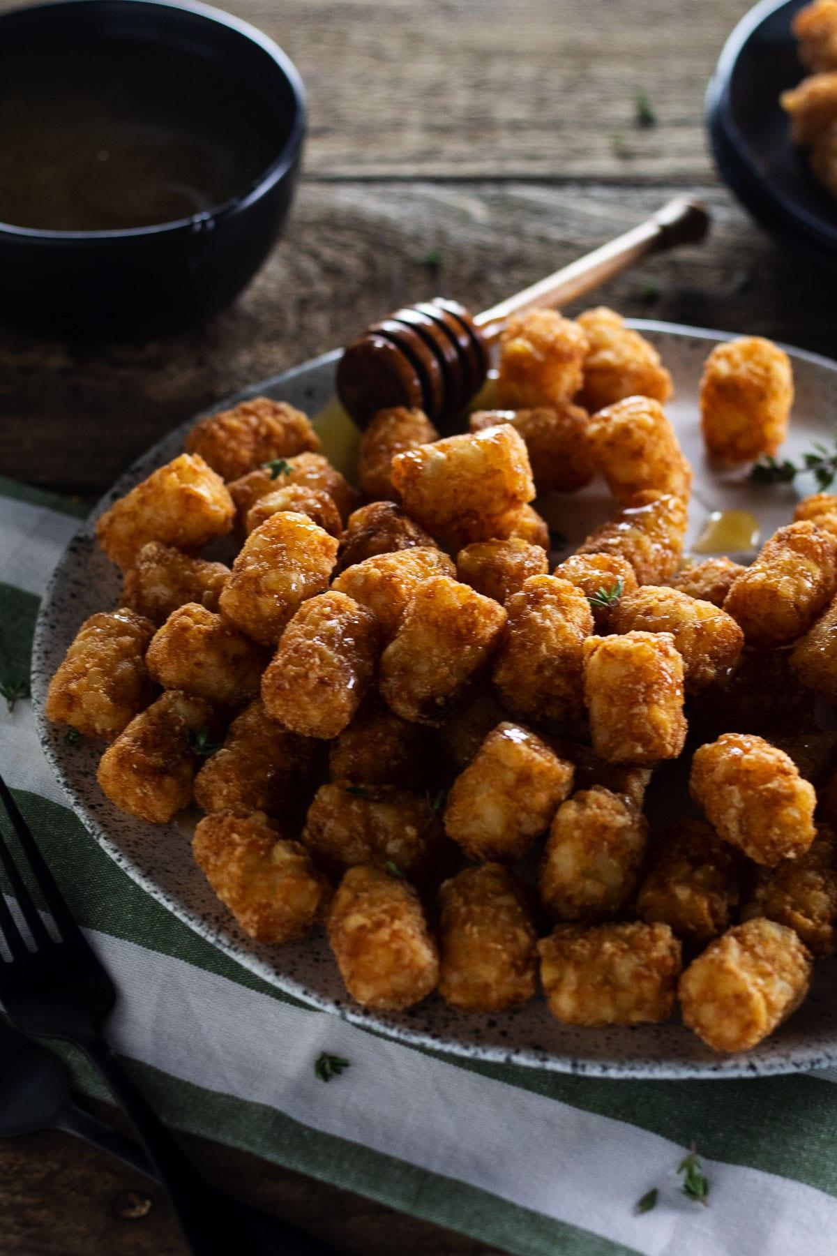 TATER TOTS IN CHICKEN SALT WITH SMOKEY HOT HONEY.