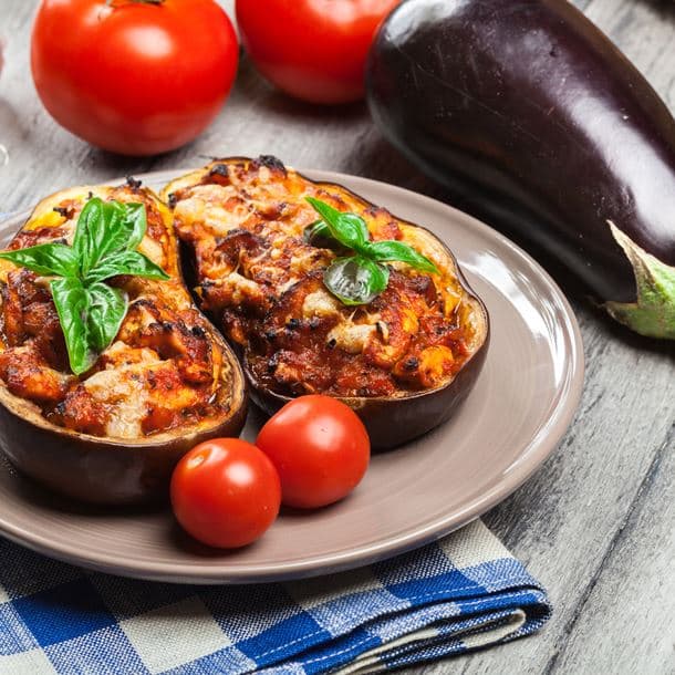 Half roasted aubergine with vegan cheese