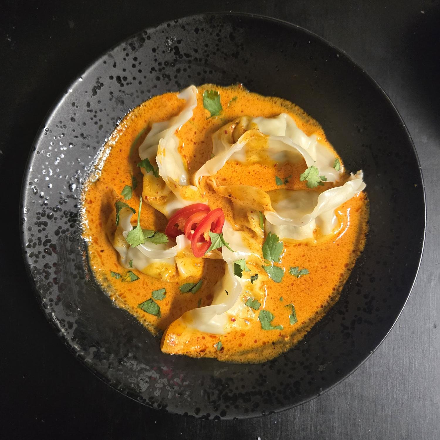 Steamed Chicken Dumplings in Red Thai Curry