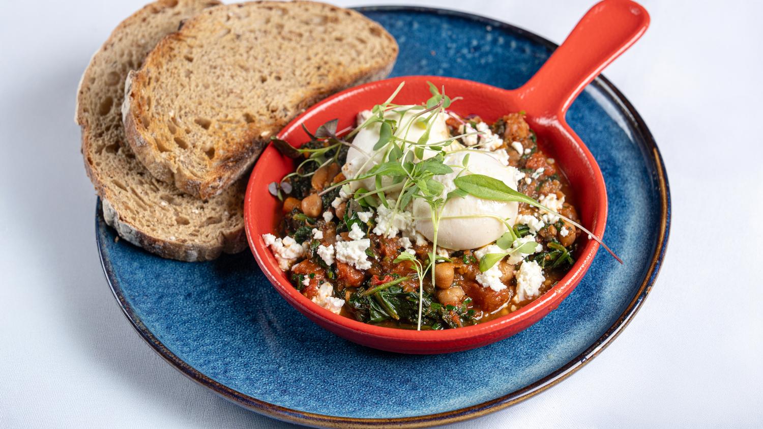 Shakshuka with poached eggs, feta crumble 