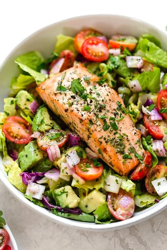 Salmon fillet on a tomato & avocado salad