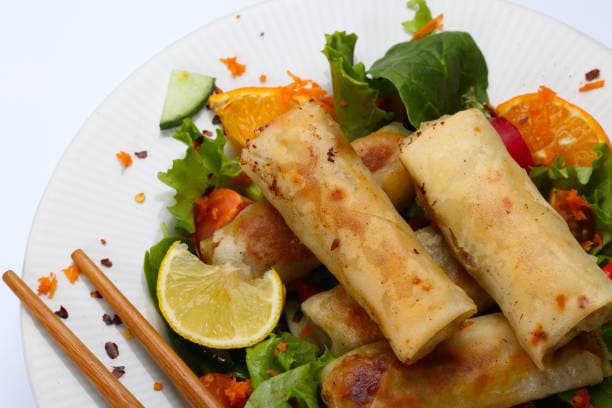 Vegetable spring rolls on oriental salad