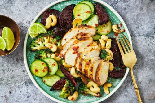 Chicken on beet root and broccoli salad